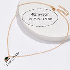 Fine Chain Necklace with Tiny Dark Stone in Gold Colour