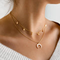 Halsband med månhänge och himmelsk charm i guldfärg