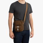 Crossbody-väska i vävt material med detaljer i konstläder
