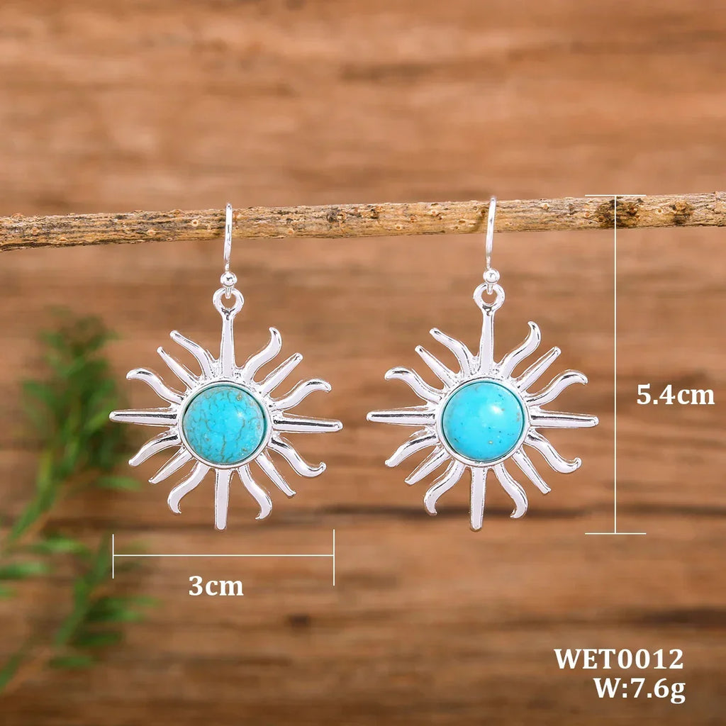 Hängande solörhängen i westernboho med blågrön sten