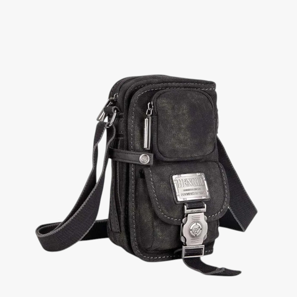 Crossbody-väska i vävt material med detaljer i konstläder