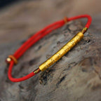 Pulsera de cordón rojo con diseño de mantra grabado