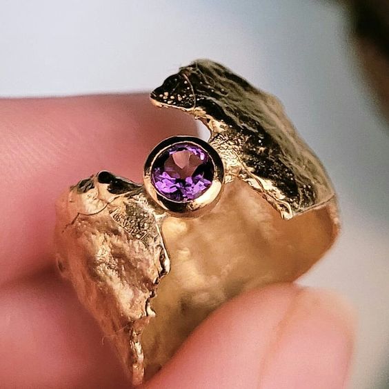 Ring i smidd stil med lila zirkonia i guldfärg