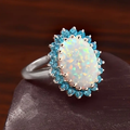 Iridescent White Stone Ring with Blue Crystal Accents
