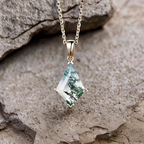 Geometriskt halsband med droppe av grön sten med mossmönster