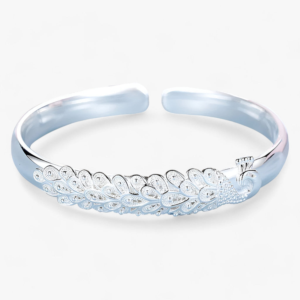 Statement-armband i metall med öppet påfågelmönster